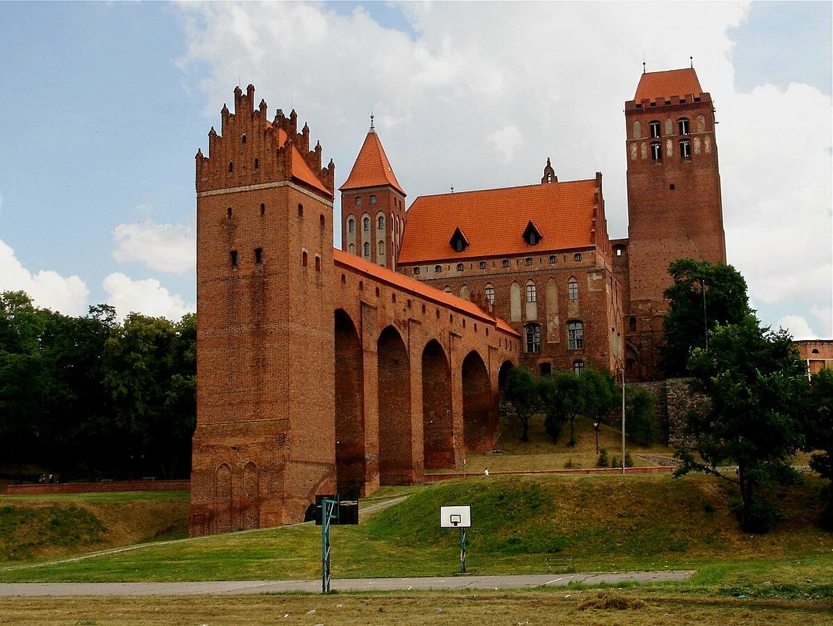 Na zdjęciu znajduje się zamek w Kwidzyniu. Jak nazywa się wieża znajdująca się poza murami obronnymi połączona z zamkiem przejściem wspartym na arkadach?