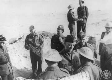 Wizyta gen. Sikorskiego (rozmawia z&nbsp;żołnierzami) w&nbsp;oddziałach polskich w&nbsp;oblężonym Tobruku. Tuż za&nbsp;nim stoi gen. Kopański, listopad 1941 roku