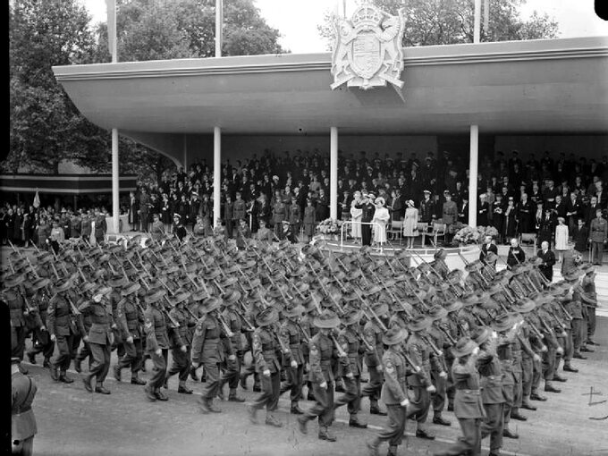 Australijscy żołnierze na paradzi zwycięstwa w Londynie, na drugim planie król Jerzy VI i królowa Elżbieta