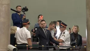 Miniatura: Kłeczek wyprowadzony z sali obrad. Jest...