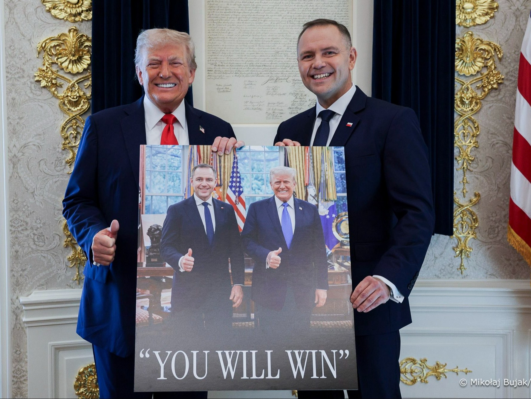 "As he announced, he did." Nawrocki and Trump pose with a photograph  from the campaign