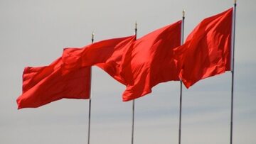 Czerwone flagi na dachu budynku. Chiny