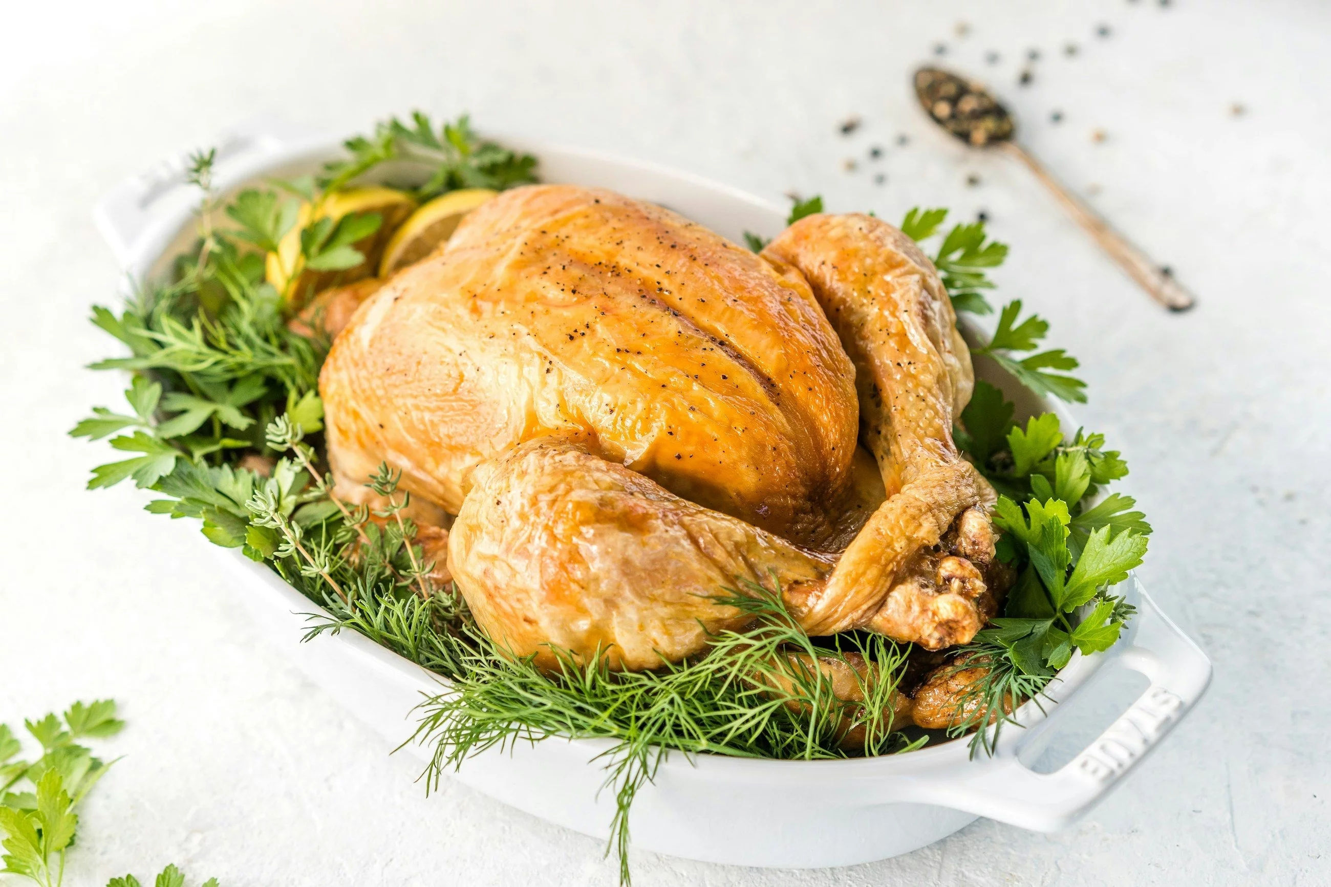 Whole roasted chicken with fresh herbs, horizontal