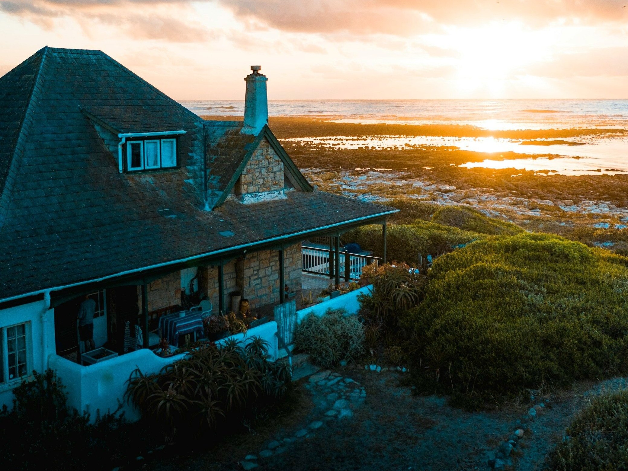 aerial photo of house near calm body of water