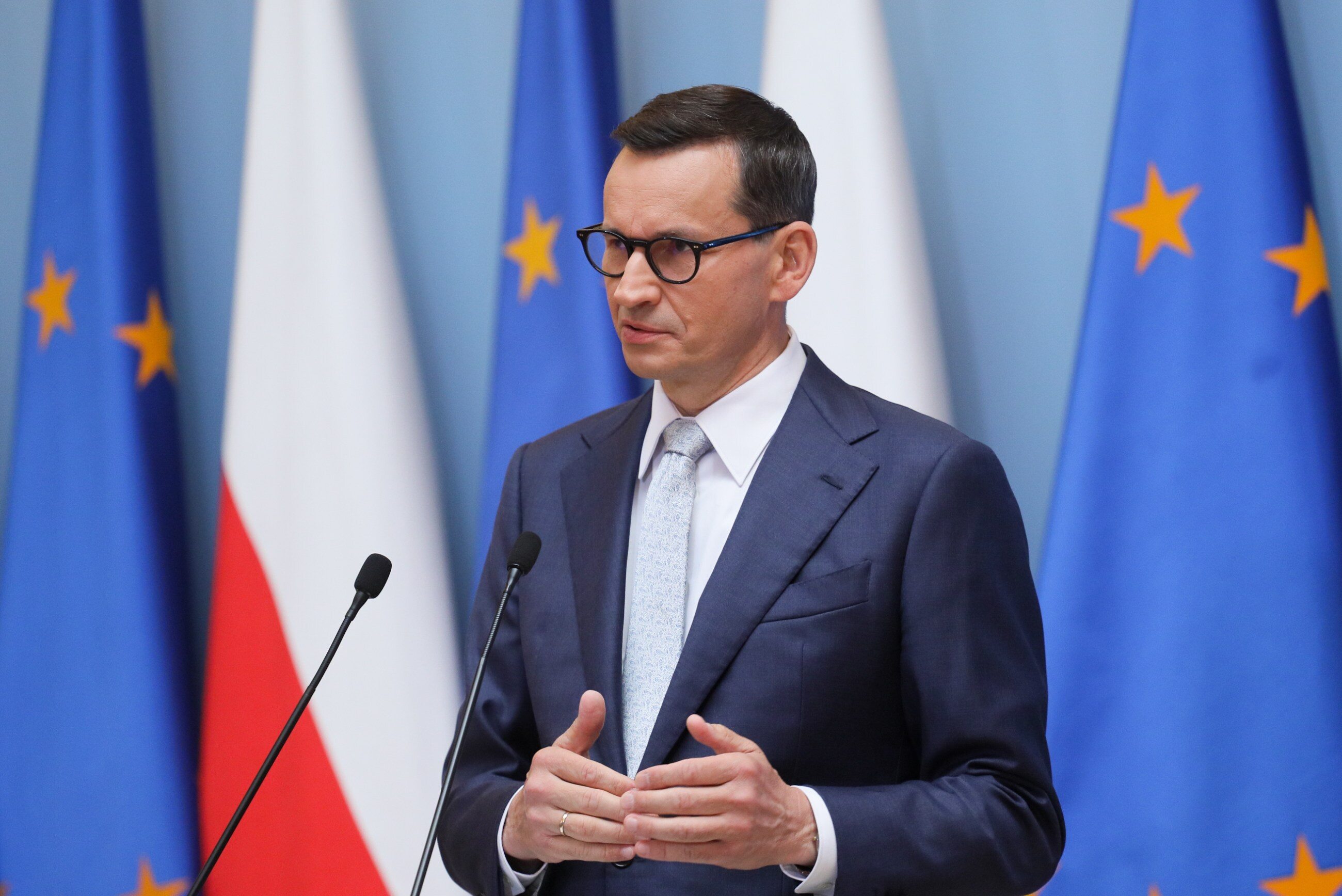 prompthunt: screenshot of a smiling muscular matusz morawiecki