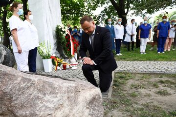 Prezydent RP Andrzej Duda (C) 1 bm. w Warszawie, podczas uroczystości złożenia wieńca przed pomnikiem upamiętniającym ofiary likwidacji Szpitala Wolskiego.