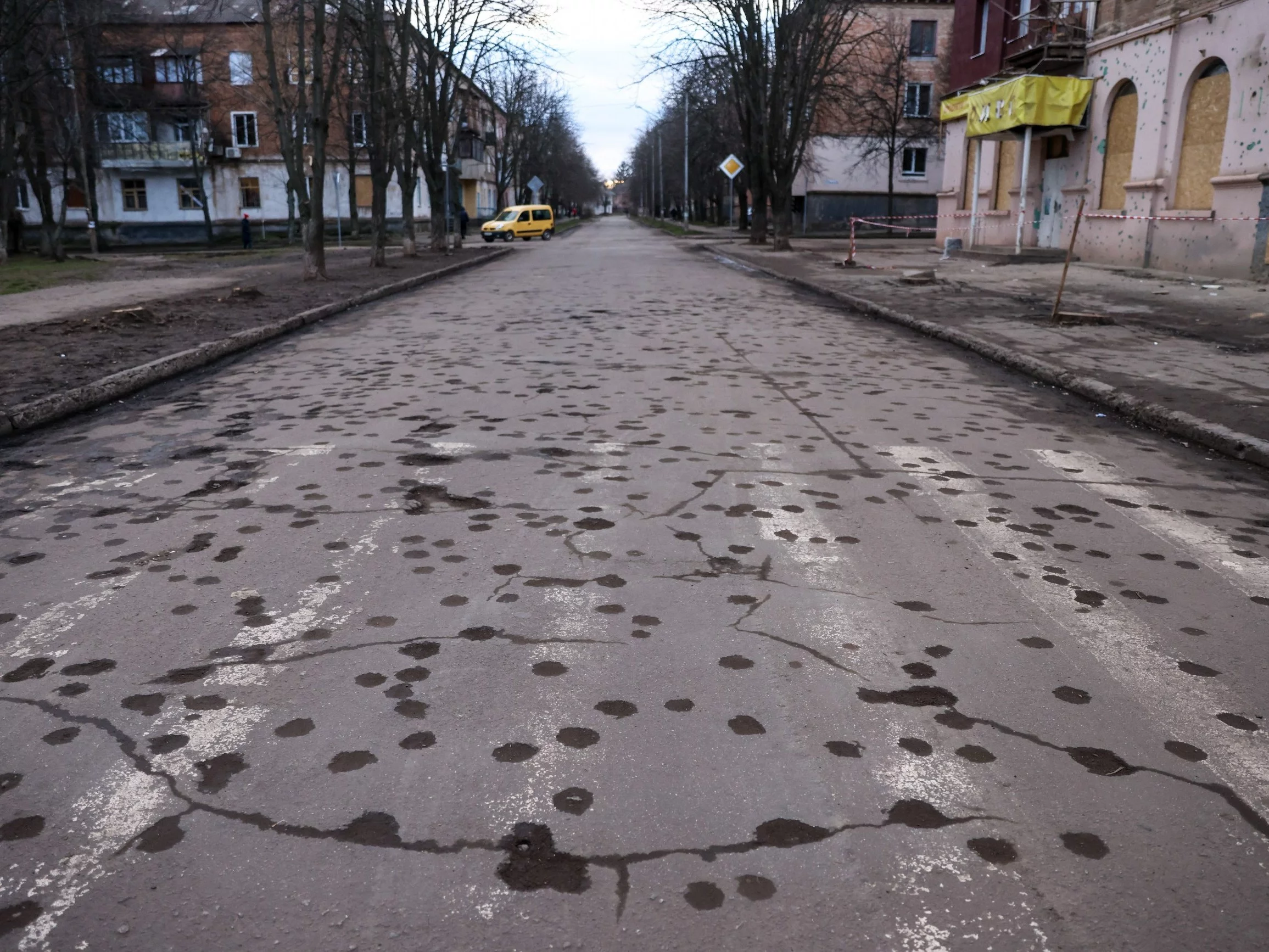 Dziury na ulicy po wybuchu rosyjskiej rakiety, która trafiła w budynek mieszkalny w Krzywym Rogu
