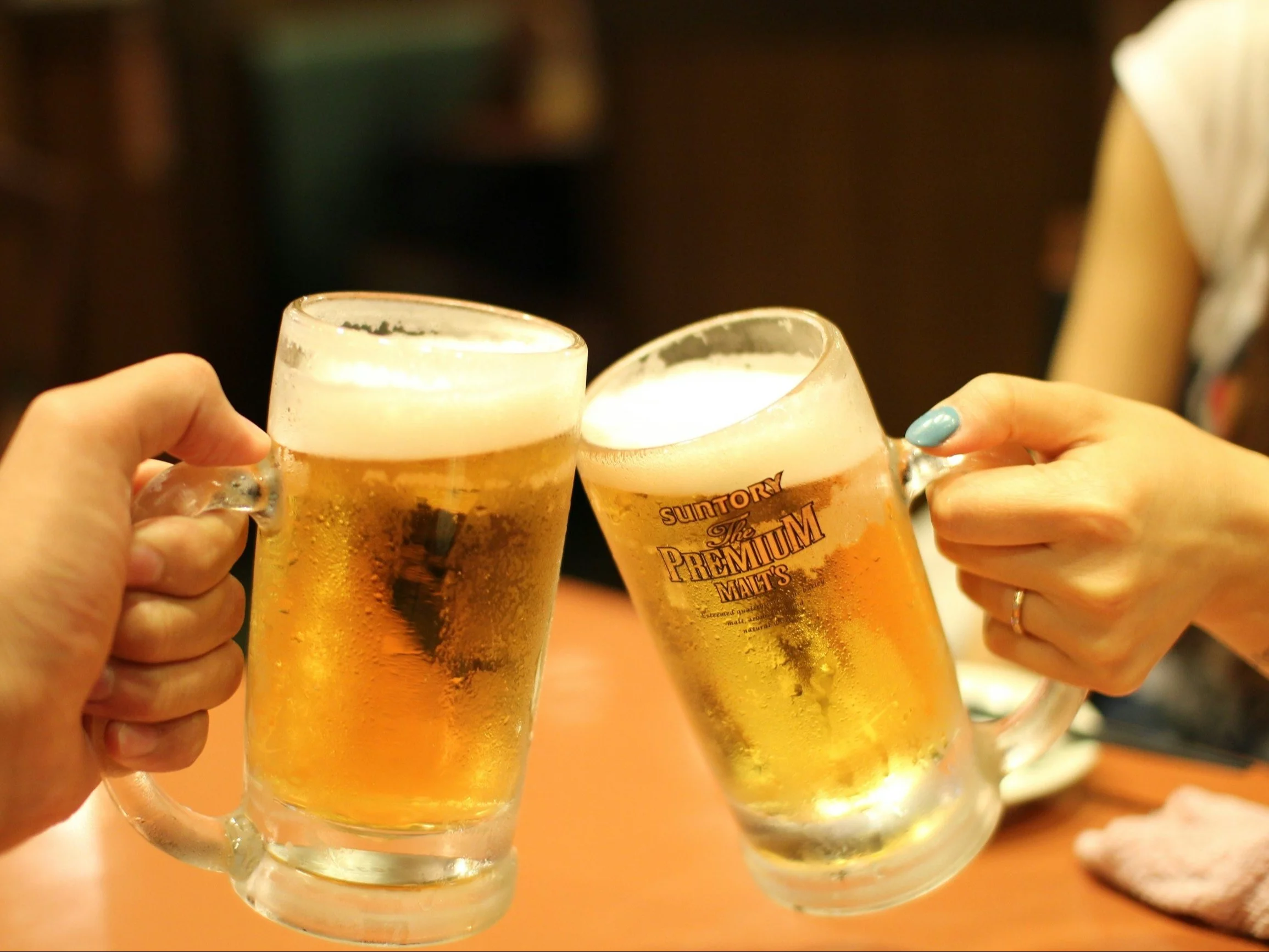 two mugs of brown liquids