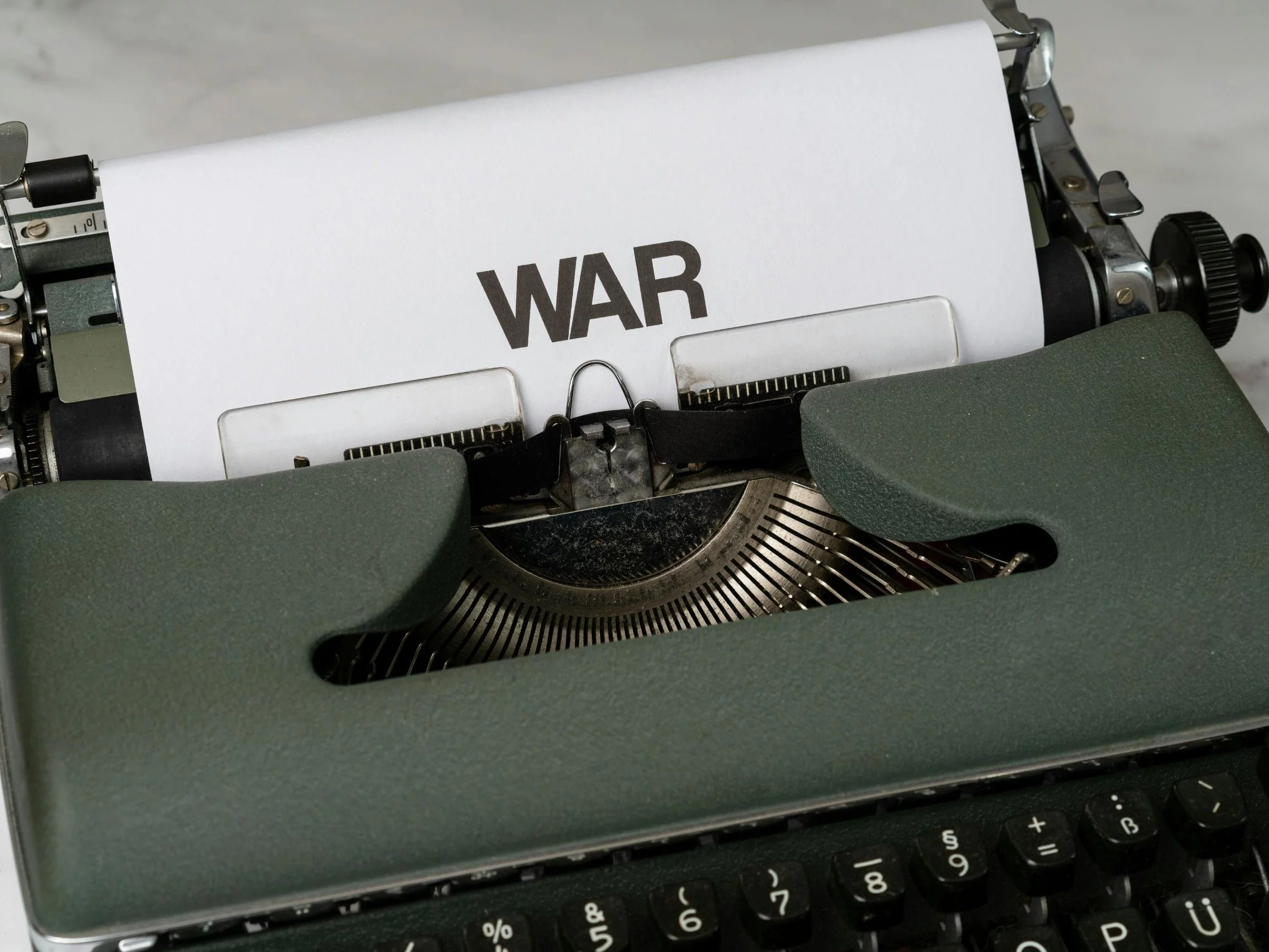 Maszyna do pisania i kartka z napisem "war". Zdj. ilustracyjne