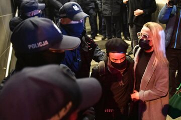 Zatrzymana podczas manifestacji przed siedzibą MEN w Warszawie, 23. bm. fotoreporterka Gazety Wyborczej Agata Grzybowska (C, w berecie) wychodzi z komendy policji na ul. Wilczej.